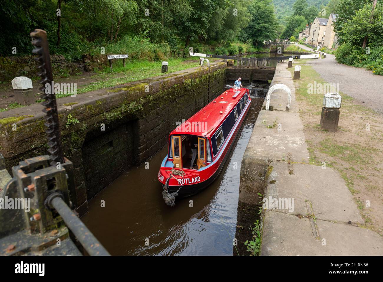 A narrow boat in the chamber of one of the locks on the Rochdale Canal at Hebden Bridge Stock Photo
