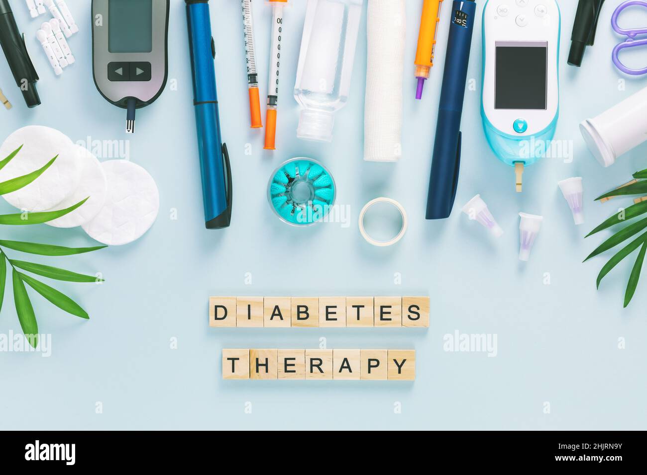 Diabetic disease concept with inscription diabetes therapy. Glucose meter with test strips for determining blood sugar levels, syringes for insulin in Stock Photo