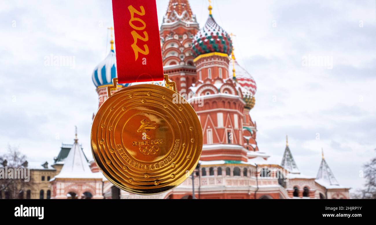 January 31, 2022, Moscow, Russia. The gold medal of the XXIV Olympic Winter Games in Beijing against the backdrop of St. Basil's Cathedral. Stock Photo