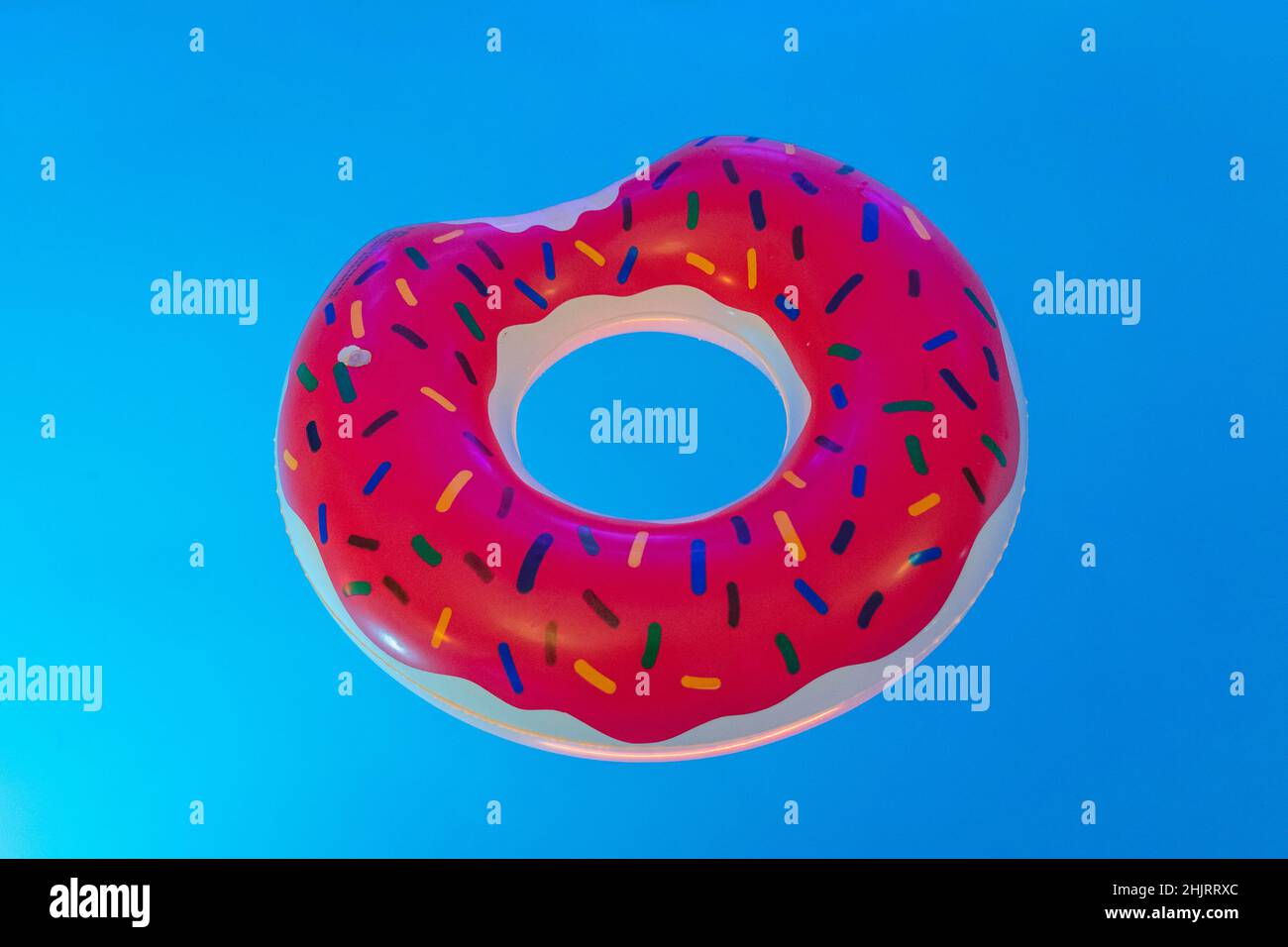 Inflatable donut ring in swimming pool Stock Photo