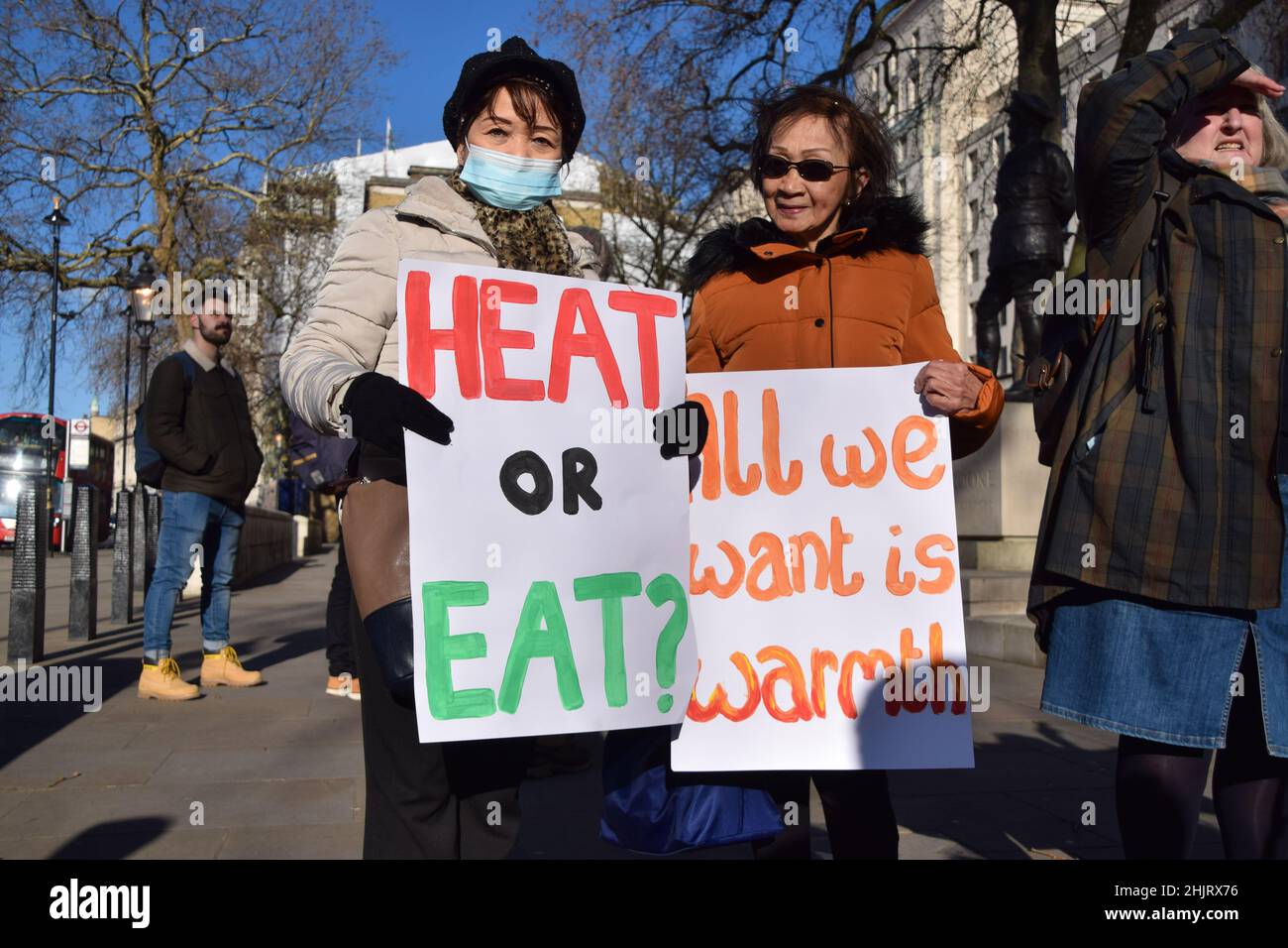 London, UK. 31st Jan, 2022. Protesters hold placards calling for help with heating bills, during the rally.Charity organisation, Age UK were joined by demonstrators outside Downing Street as they delivered a letter to Boris Johnson signed by over 97700 people, urging the government to help elderly people with their energy bills. One million older people live in fuel poverty and are unable to afford the cost of heating during winter. Credit: SOPA Images Limited/Alamy Live News Stock Photo