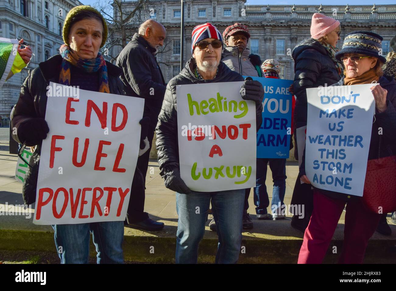 London, UK. 31st Jan, 2022. Protesters hold placards calling for an end to fuel poverty and help with heating bills, during the rally.Charity organisation, Age UK was joined by demonstrators outside Downing Street as they delivered a letter to Boris Johnson signed by over 97700 people, urging the government to help elderly people with their energy bills. One million older people live in fuel poverty and are unable to afford the cost of heating during winter. Credit: SOPA Images Limited/Alamy Live News Stock Photo
