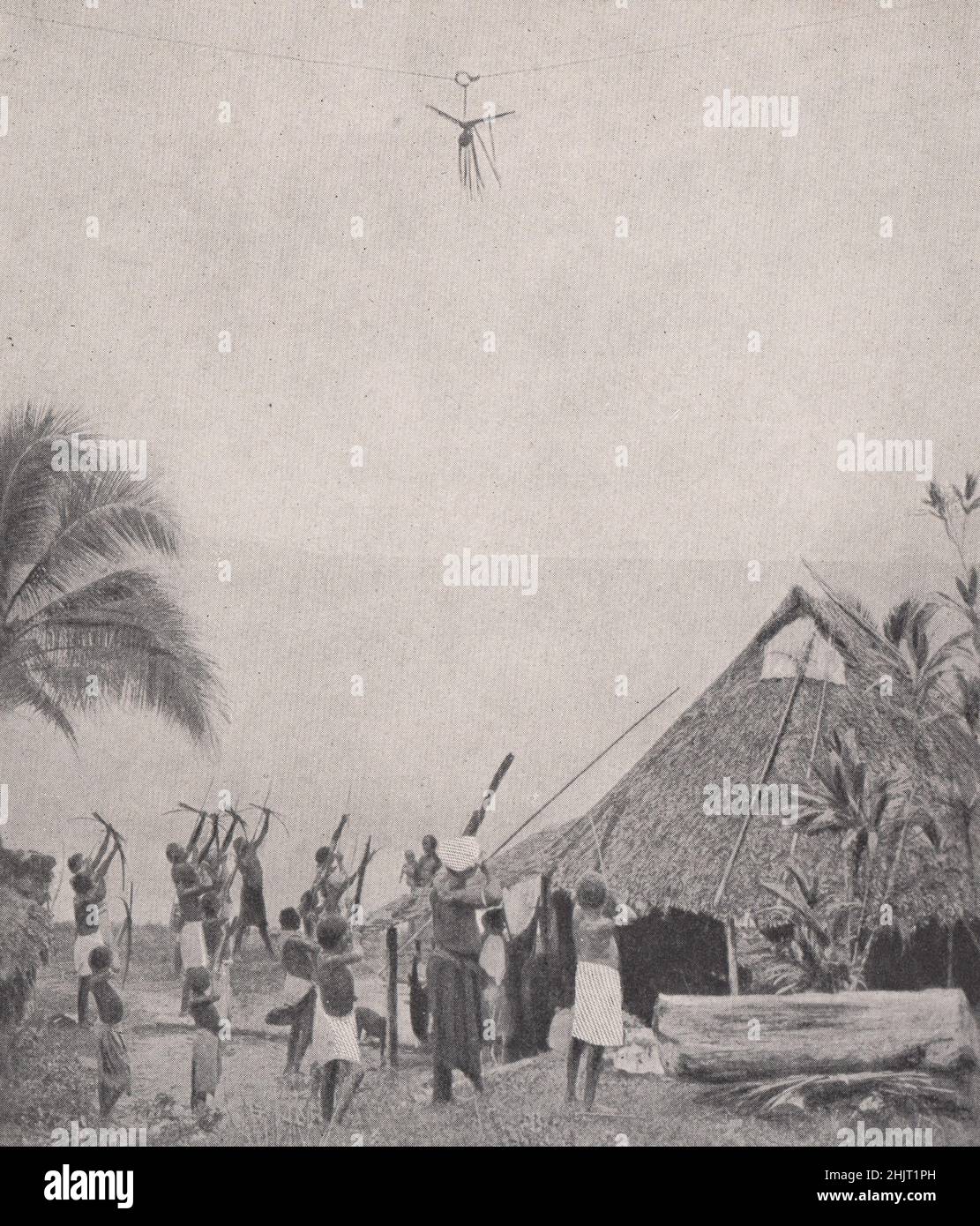 Young archers testing their skill with an aerial target. South Pacific Islands (1923) Stock Photo