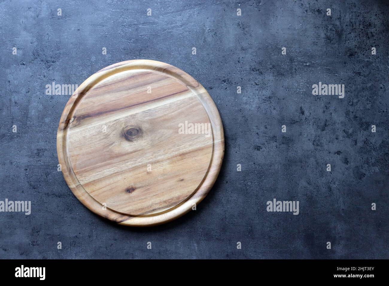 Rustic Handmade Round Wooden Chopping Board on Granite Stock Photo