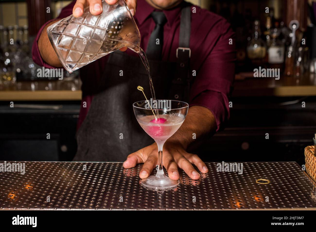 Bartender pouring gin cocktail in cocktail lounge Stock Photo