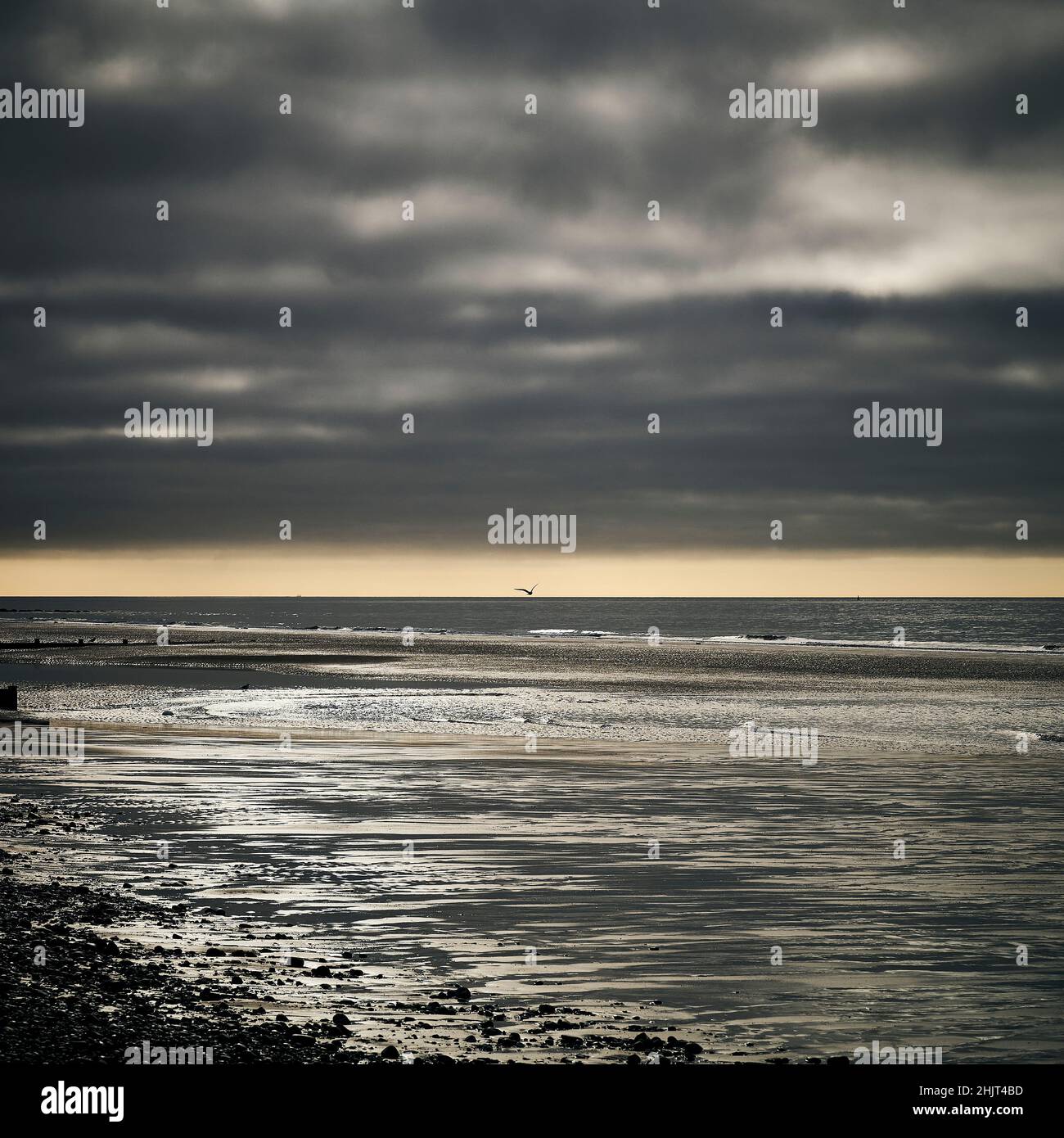 Storm approching over empty beach in winter Stock Photo