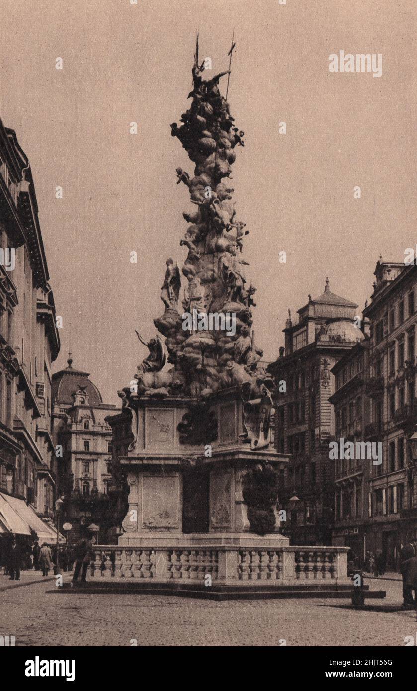 In the middle of the Graben, the chief shopping Street, is the Trinity Column, raised after the horrible plague of 1679. Austria. Vienna (1923) Stock Photo