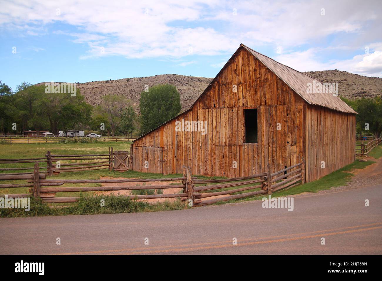 The traditional Gifford Homestead wooden house with the red gravel road