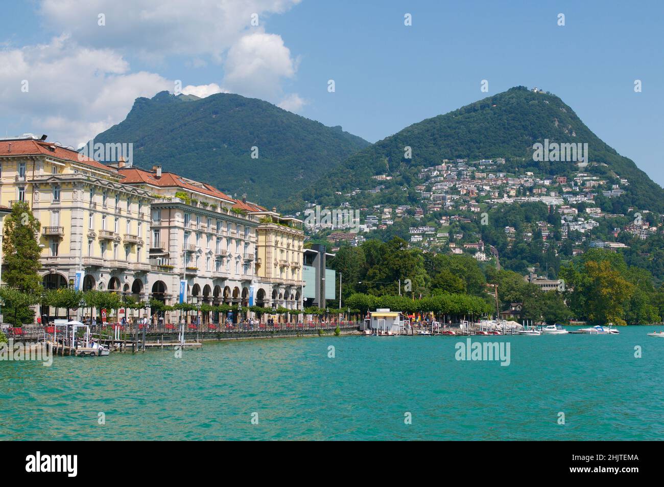 Beautiful view of some old buildings of Lugano Switzerland seen from the lake on a sunny day in summer Stock Photo