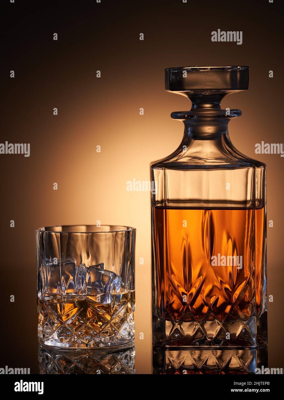 Scotch whiskey with ice in a glass and a bottle Stock Photo Alamy