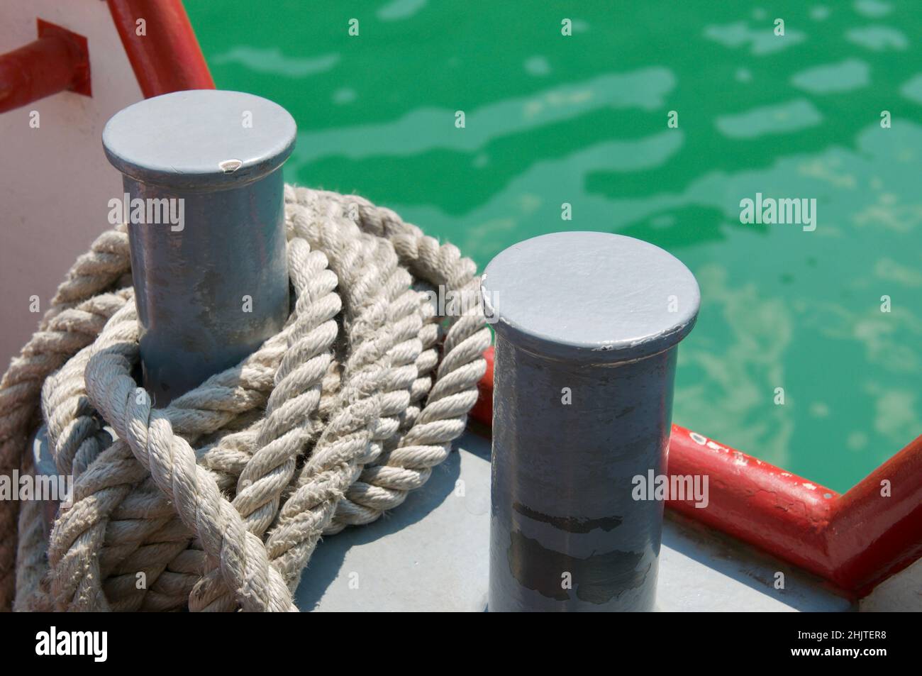 Close up picture of two bollards with mooring rope of a tourism boat on the lake Lugano, Switzerland Stock Photo