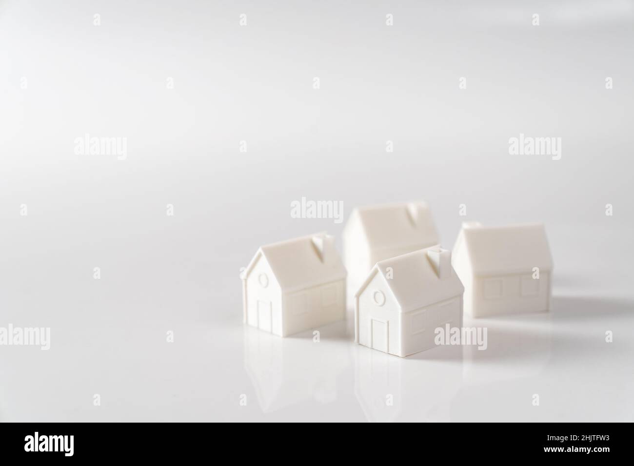 Miniature 3D printed model house on white background Stock Photo
