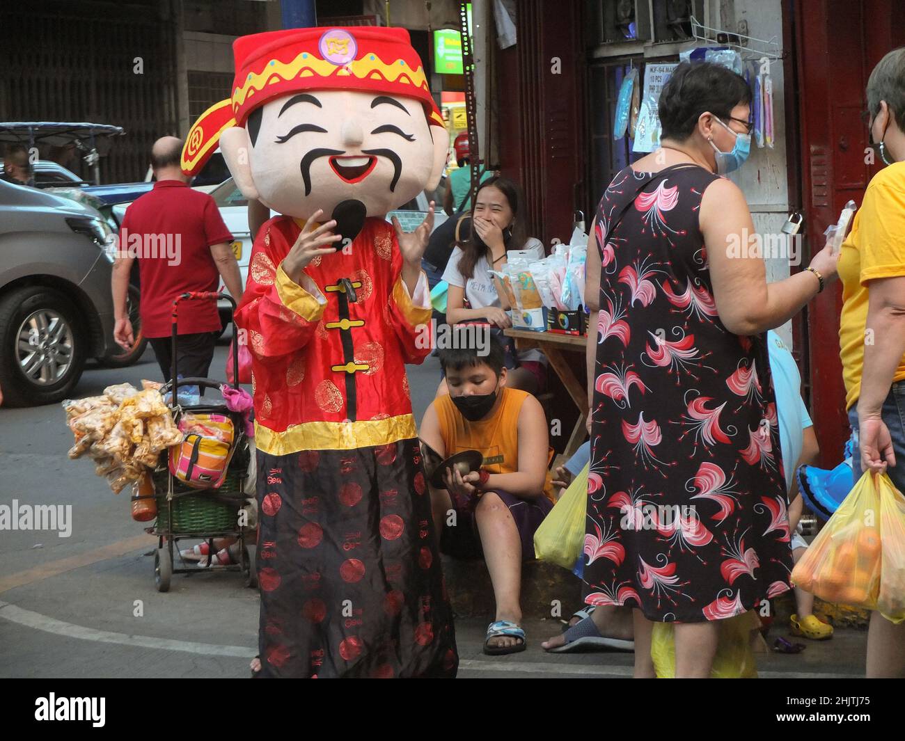 Manila, Philippines. 31st Jan, 2022. A boy dressed up as Caishen, the God of wealth in Taoism seen at the corner of Ongpin street during the new years eve.The city government of Manila bans all public Chinese new year festivities and called upon officials of the Chinatown district to strictly implement the executive order and the minimum health standards as the covid-19 remains a threat. This is the second year that the city cancels the public Lunar or Chinese New Year celebrations. Credit: SOPA Images Limited/Alamy Live News Stock Photo