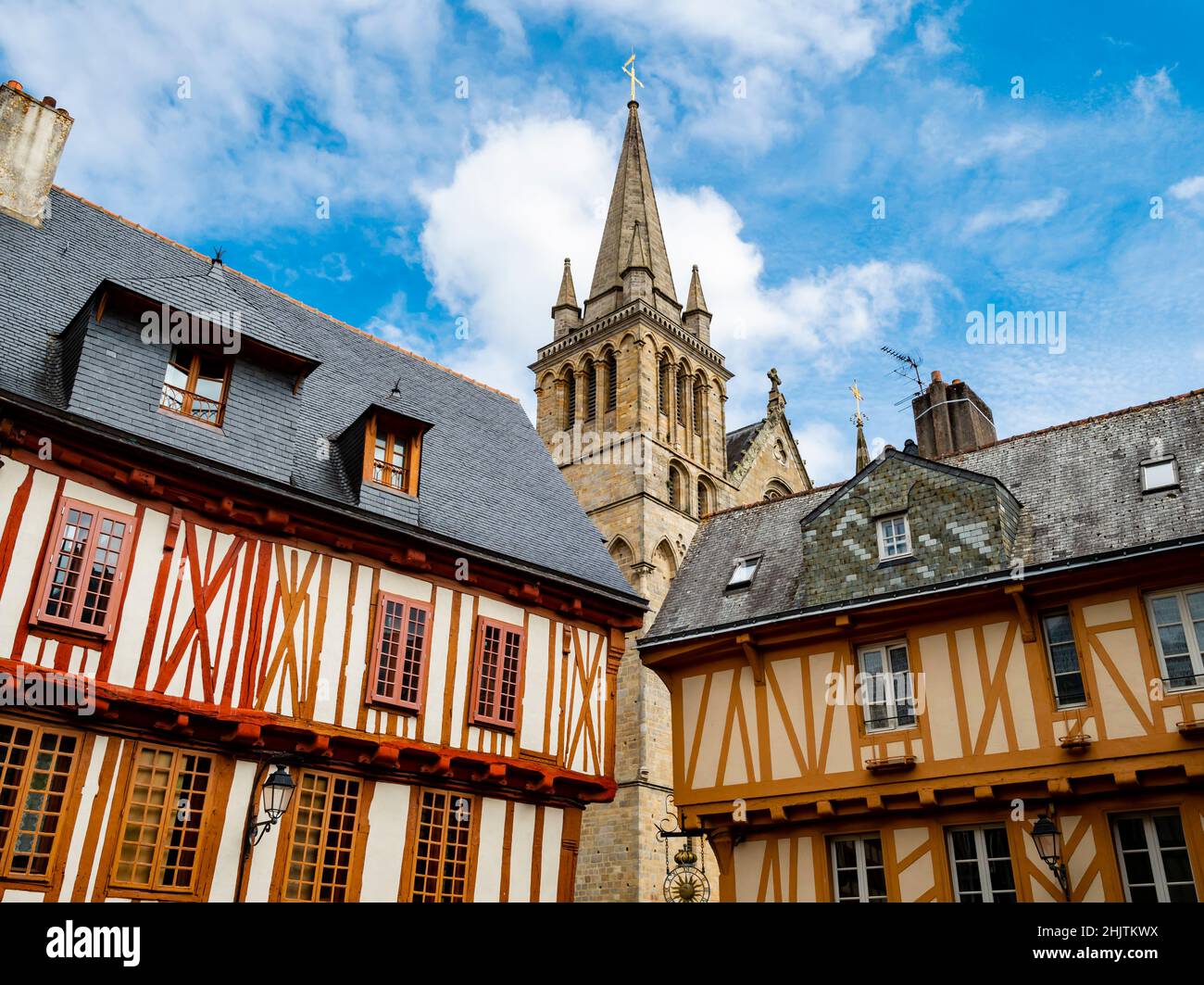 Colorful old wooden houses and St. Peter's Basilica in the historical center of Vannes, coastal medieveal town in Morbihan departement, Brittany, Fran Stock Photo