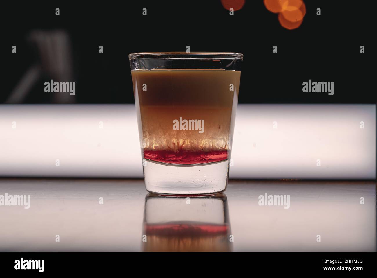Brain Hemorrhage Tornado in shot alcohol drink based on cream, liqueur and grenadine with baileys Stock Photo