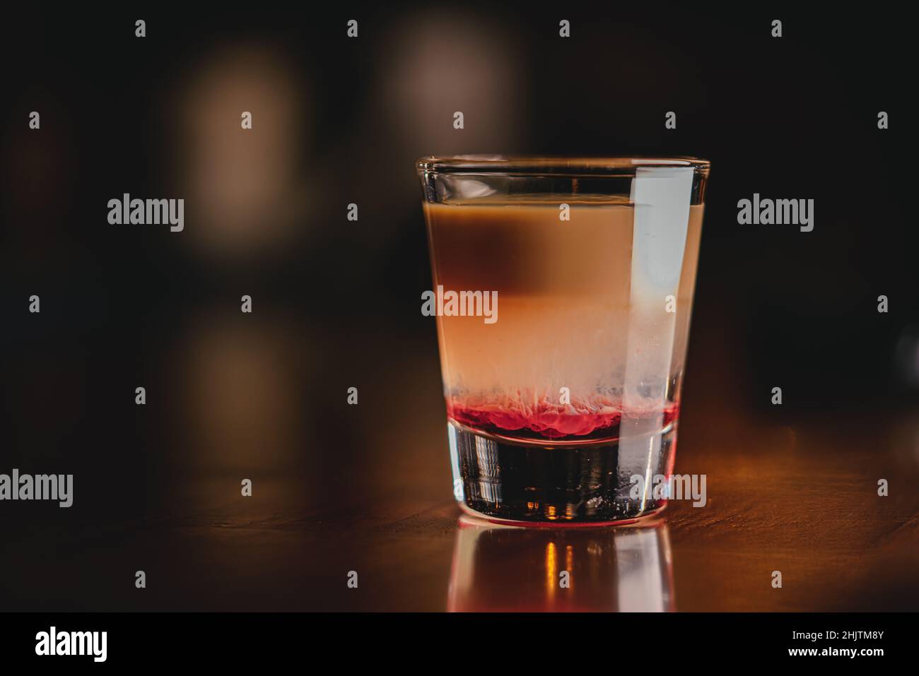 Brain Hemorrhage Tornado in shot alcohol drink based on cream, liqueur and grenadine with baileys Stock Photo