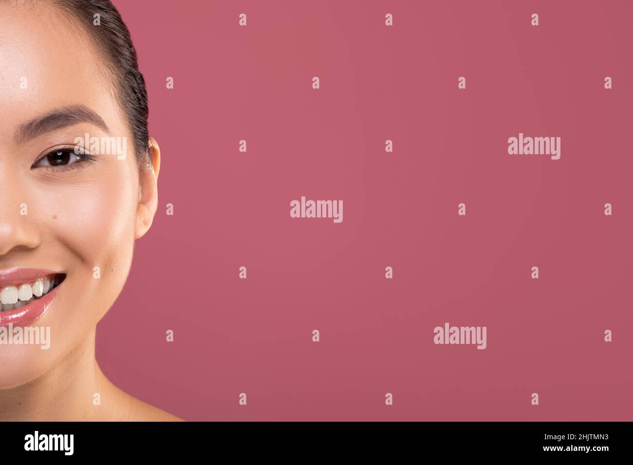 Half face of asian woman enjoying her beauty routine Stock Photo