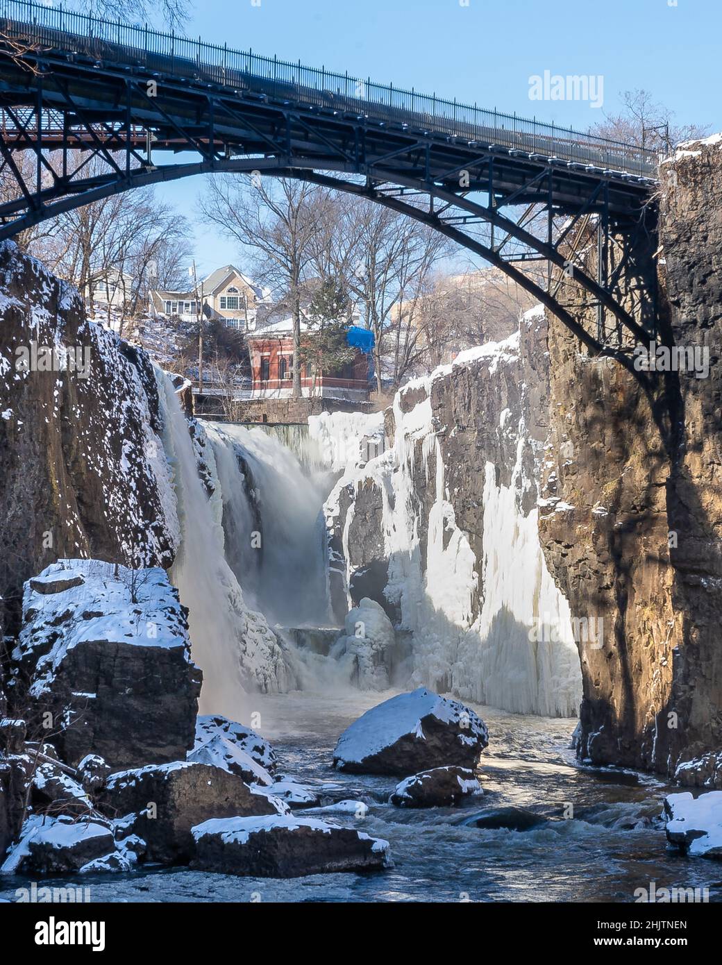 Paterson, NJ - USA - Jan 30, 2022 Vertical closeup view of the partially frozen falls at historic Paterson Great Falls National Historical Park during Stock Photo