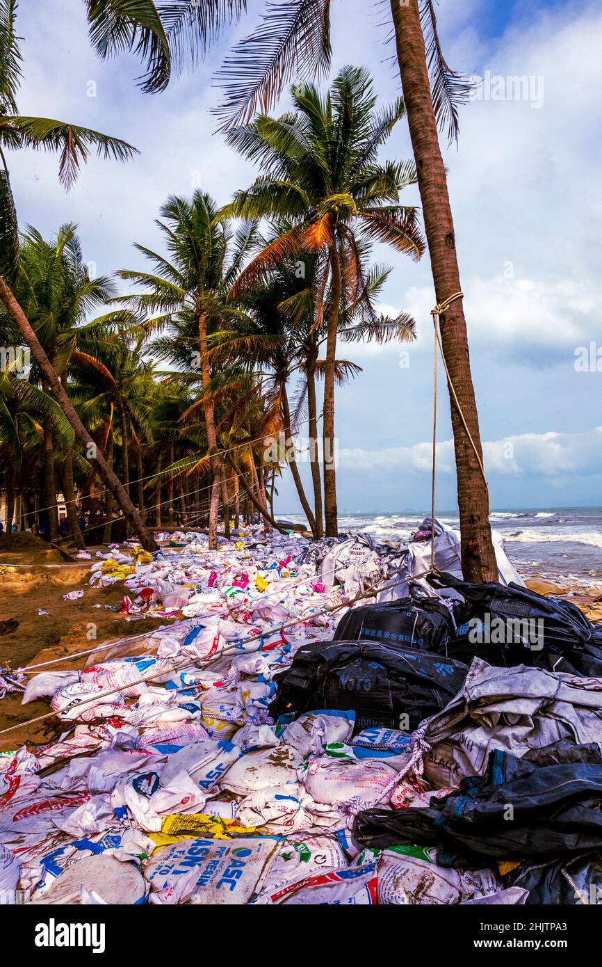 Cua Dai Beach after a big storm caused beach erosion and piles of trash or debris on the beach. Stock Photo