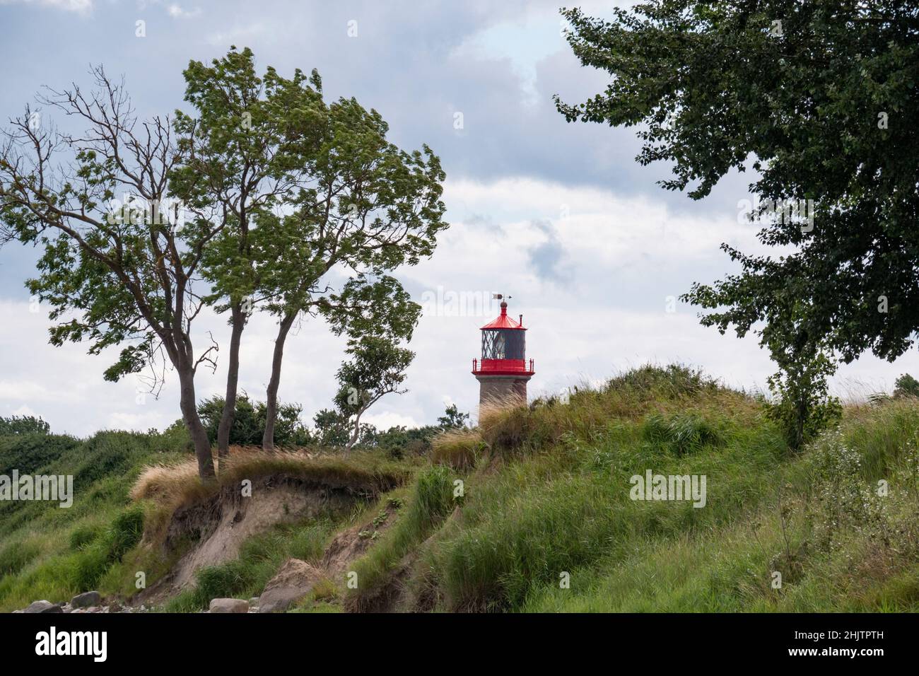 Green coastal landscape with the lighthouse Saberhuk in the background, Fehmarn Island, Germany Stock Photo