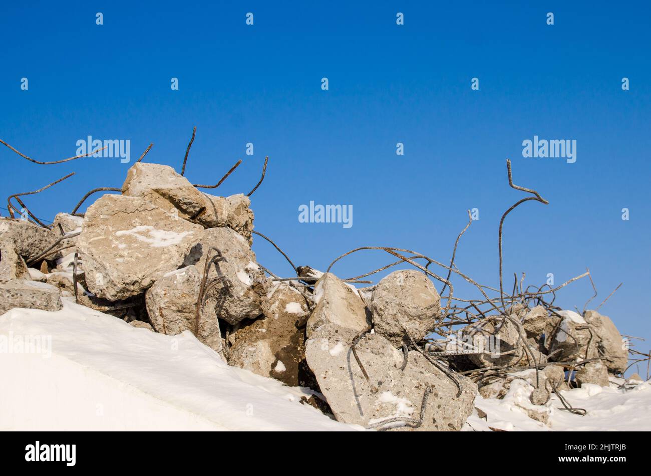 Pieces of concrete with reinforcement from destroyed structures. Stock Photo
