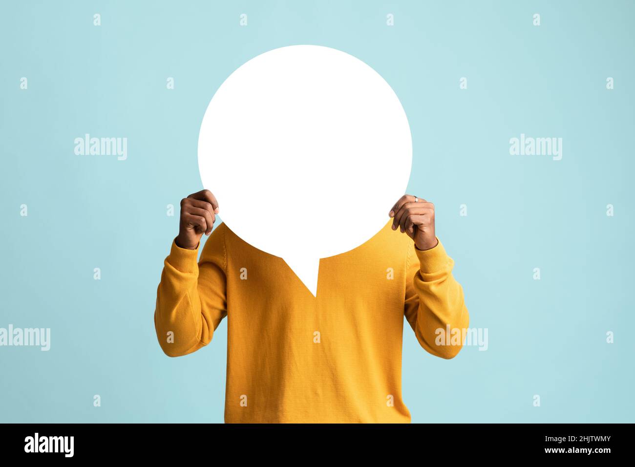 Black man hiding behind empty communication chart Stock Photo