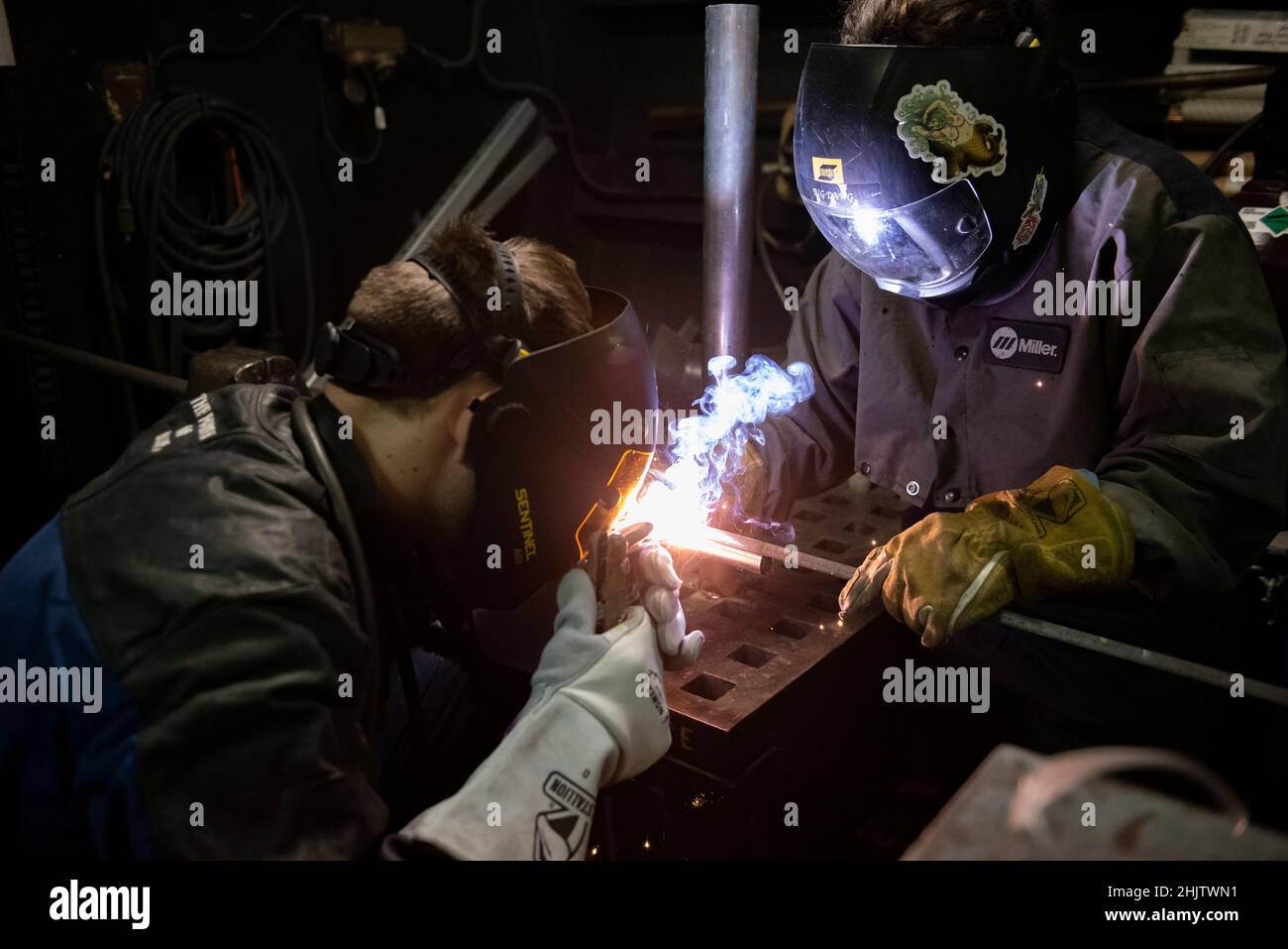 U.S. Coast Guard Petty Officer 3rd Class Colin Forey (left), and Petty Officer 2nd Class Rachel Hansen, both damage controlman aboard the USCGC Stratton (WMSL 752), conduct welding training in the Pacific Ocean, Dec. 31, 2021. The Stratton crew strives to build teamwork through training that enhances the overall morale while underway. (U.S. Coast Guard photo by U.S. Marine Corps Sgt. Sarah Stegall) Stock Photo