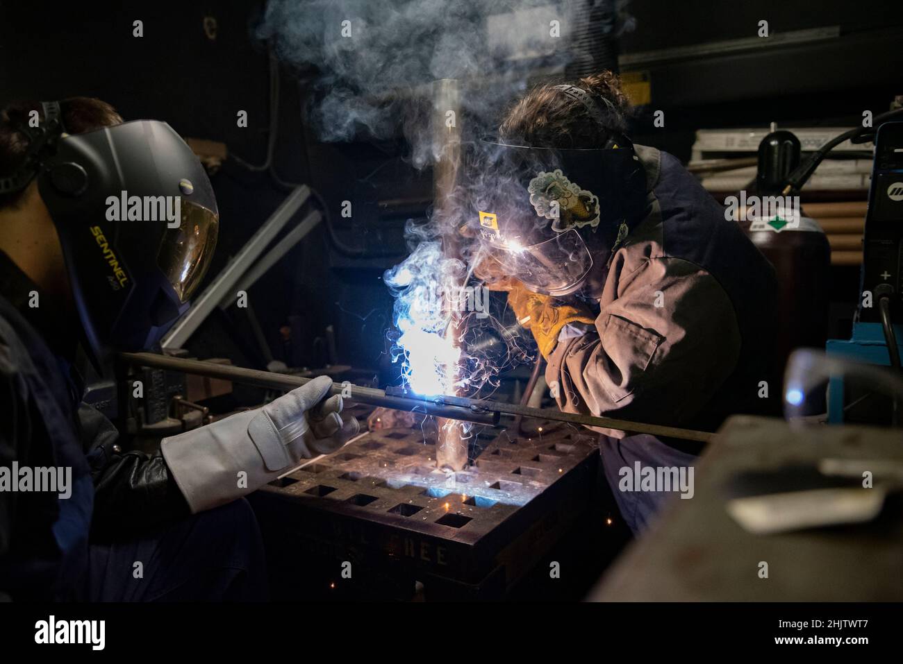 U.S. Coast Guard Petty Officer 3rd Class Colin Forey (left), and Petty Officer 2nd Class Rachel Hansen, both damage controlman aboard the USCGC Stratton (WMSL 752), conduct welding training in the Pacific Ocean, Dec. 31, 2021. The Stratton crew strives to build teamwork through training that enhances the overall morale while underway. (U.S. Coast Guard photo by U.S. Marine Corps Sgt. Sarah Stegall) Stock Photo