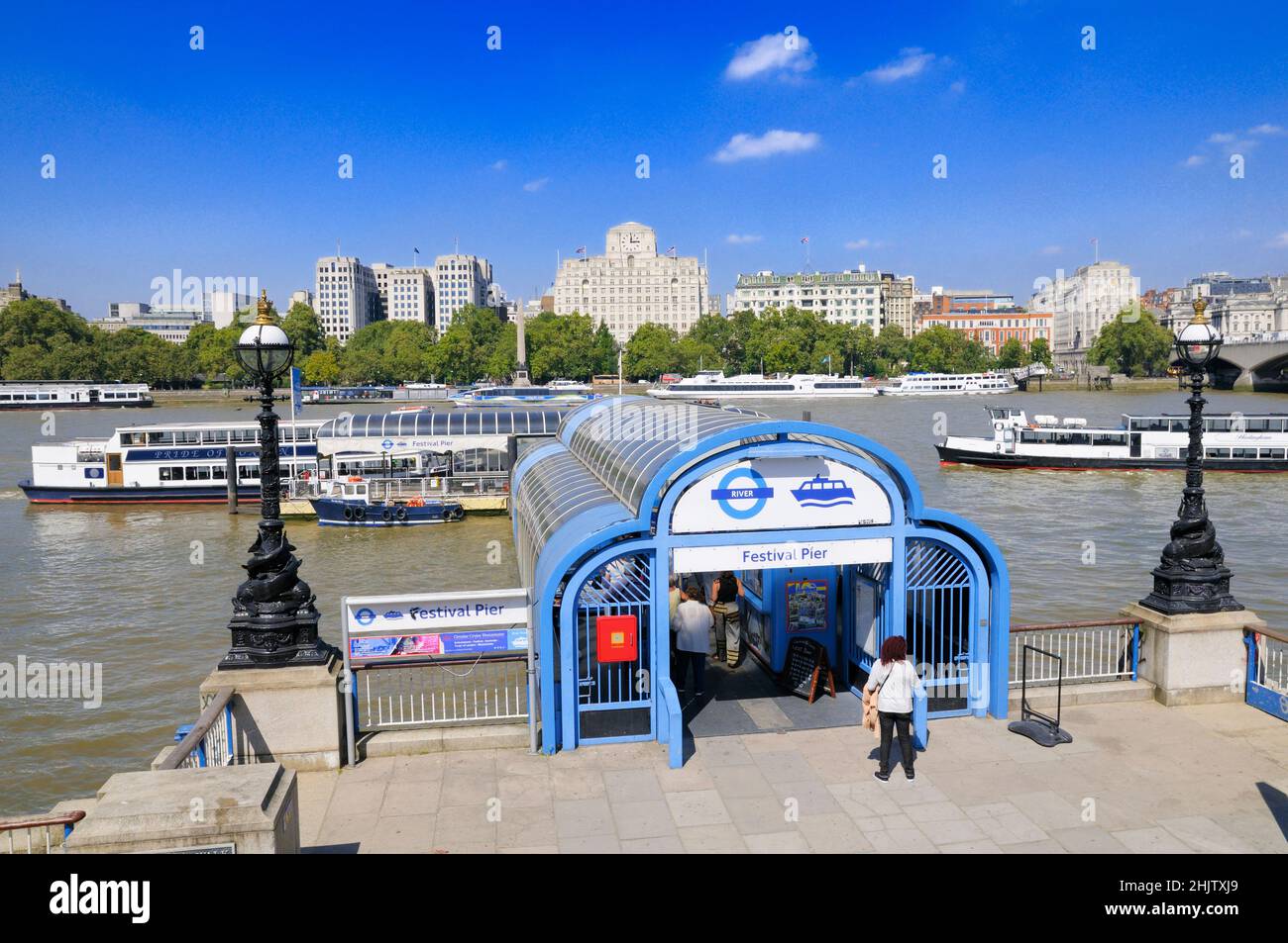 View from Festival Pier on the South Bank across a busy River Thames to Victoria Embankment, London, England, UK Stock Photo