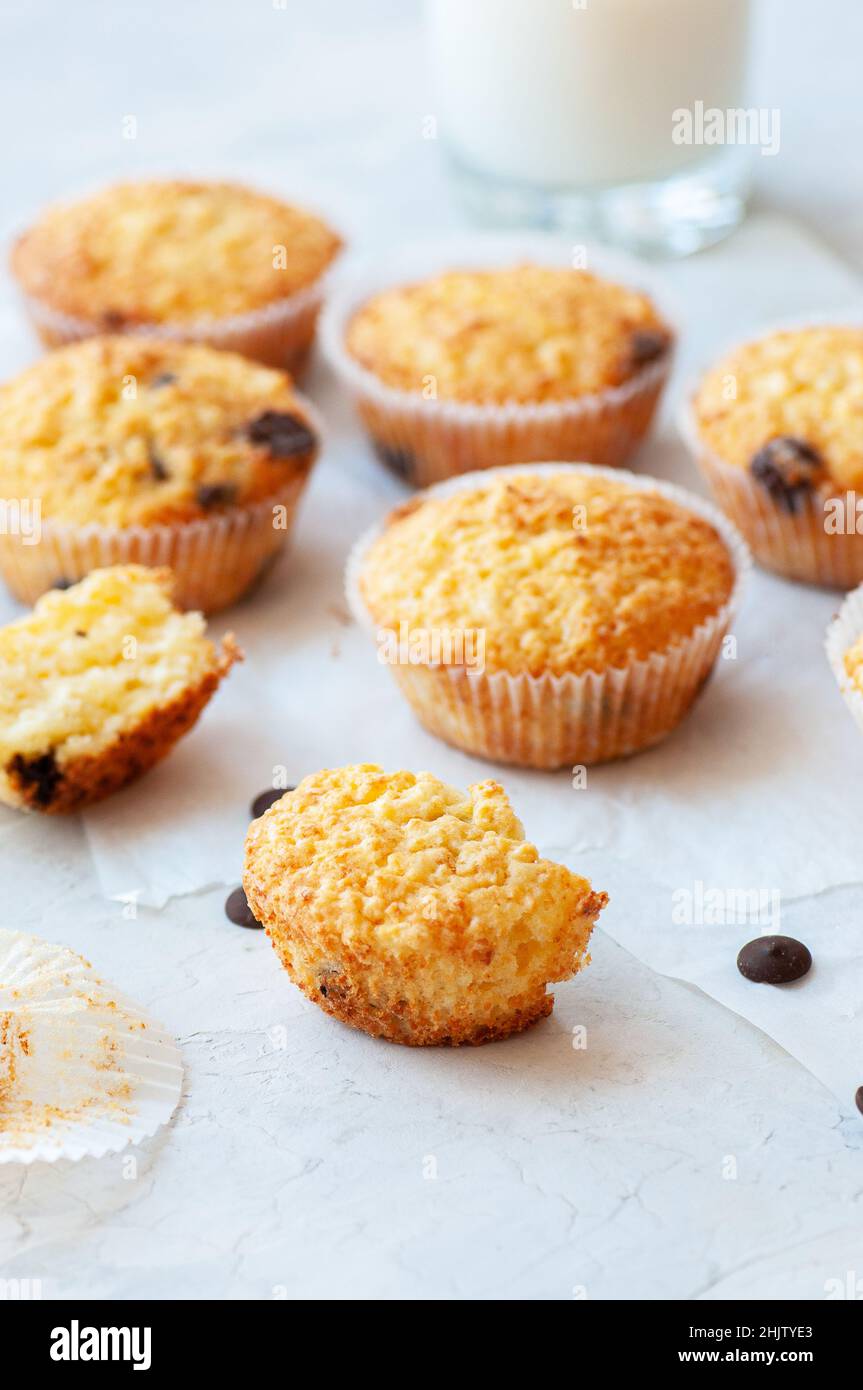 Homemade easy muffins with chocolate chips and glass of milk. Stock Photo