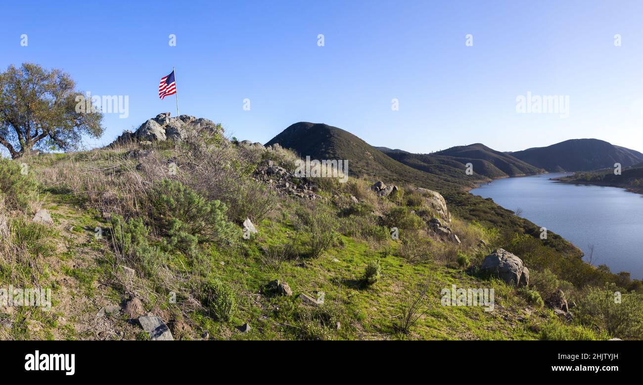 Scenic View of Beautiful Lake Hodges in San Dieguito River Park, Southern California from Fletcher Point Peninsula with American Flag on Highest Point Stock Photo