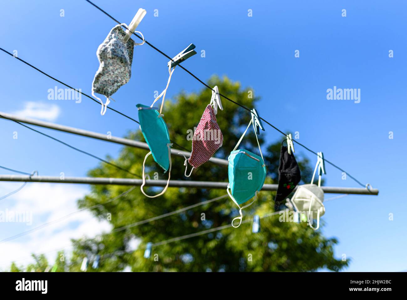 A mix of masks hanging on a Hills Hoist during the 2022 summer in ...