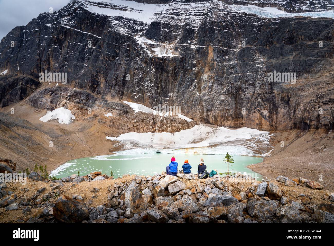 A single mother and her two children overlooking a melting glacier at Edith Cavell Meadows Jasper National Park Canada Stock Photo