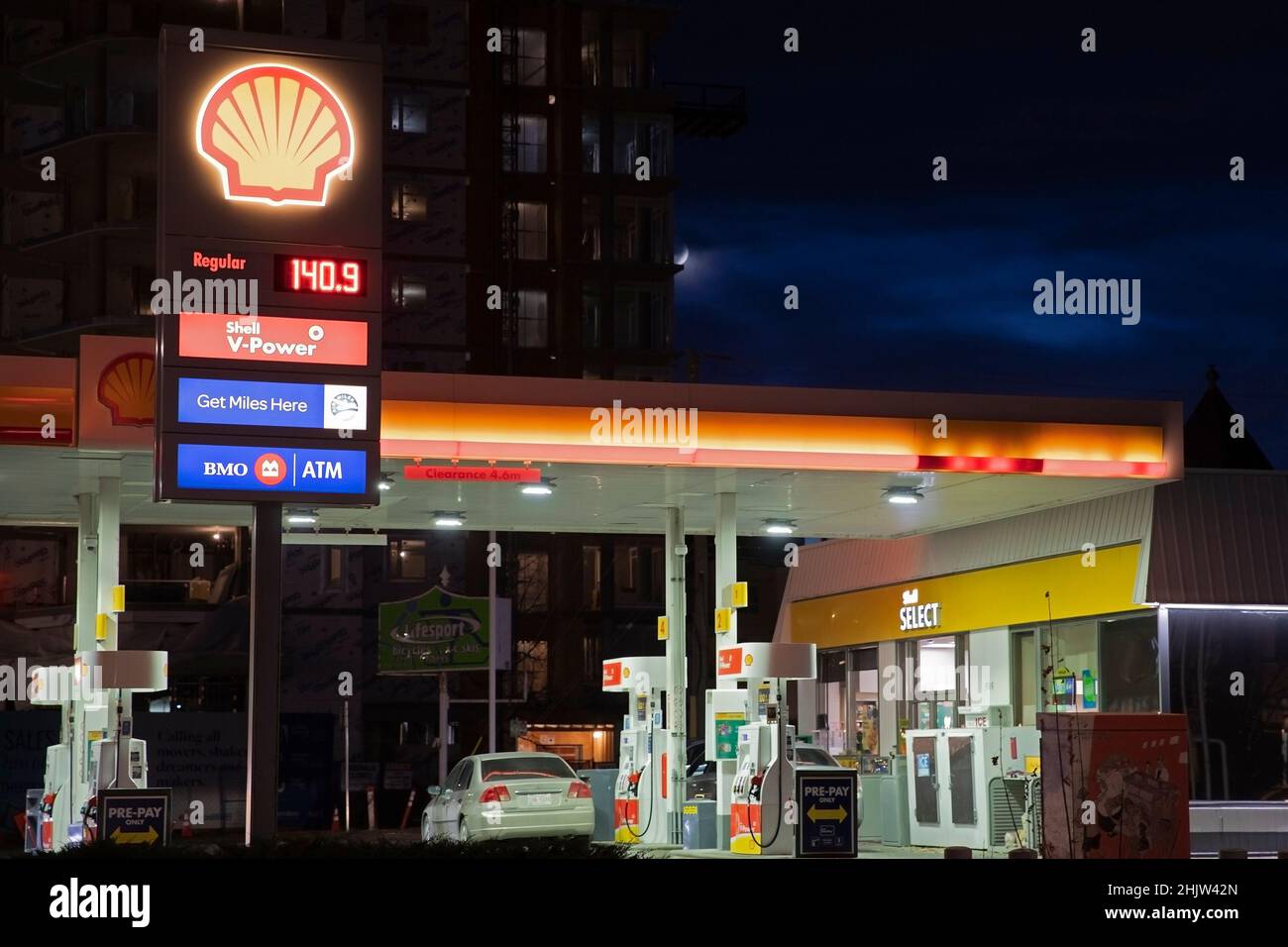 Shell service station at night with sign showing price of gas per litre in 2021, Calgary, Alberta, Canada Stock Photo