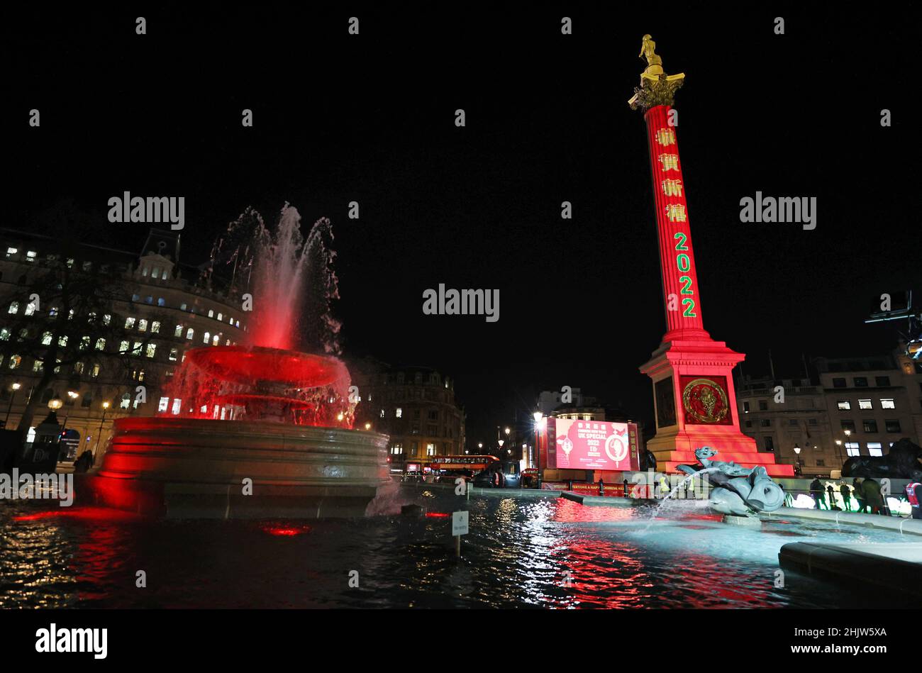 London, UK. 31st Jan, 2022. Photo taken on Jan. 31, 2022 shows the Nelson's Column and a fountain illuminated in red to celebrate the Chinese Lunar New Year at Trafalgar Square in London, Britain. Credit: Li Ying/Xinhua/Alamy Live News Stock Photo