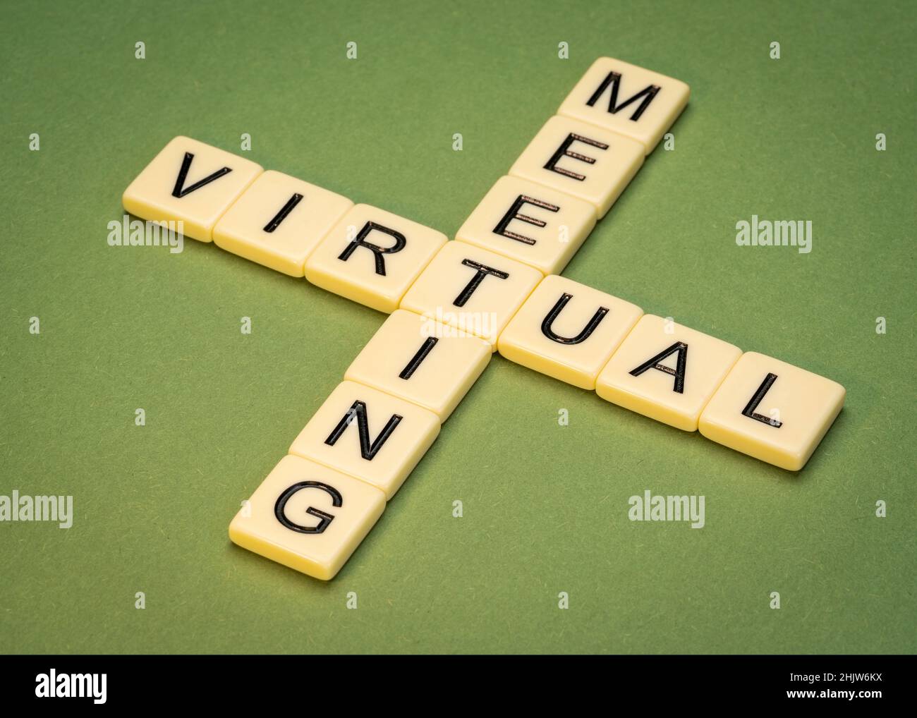 virtual meeting crossword in ivory letter tiles against textured virtual meeting crossword in ivory letter tiles against textured