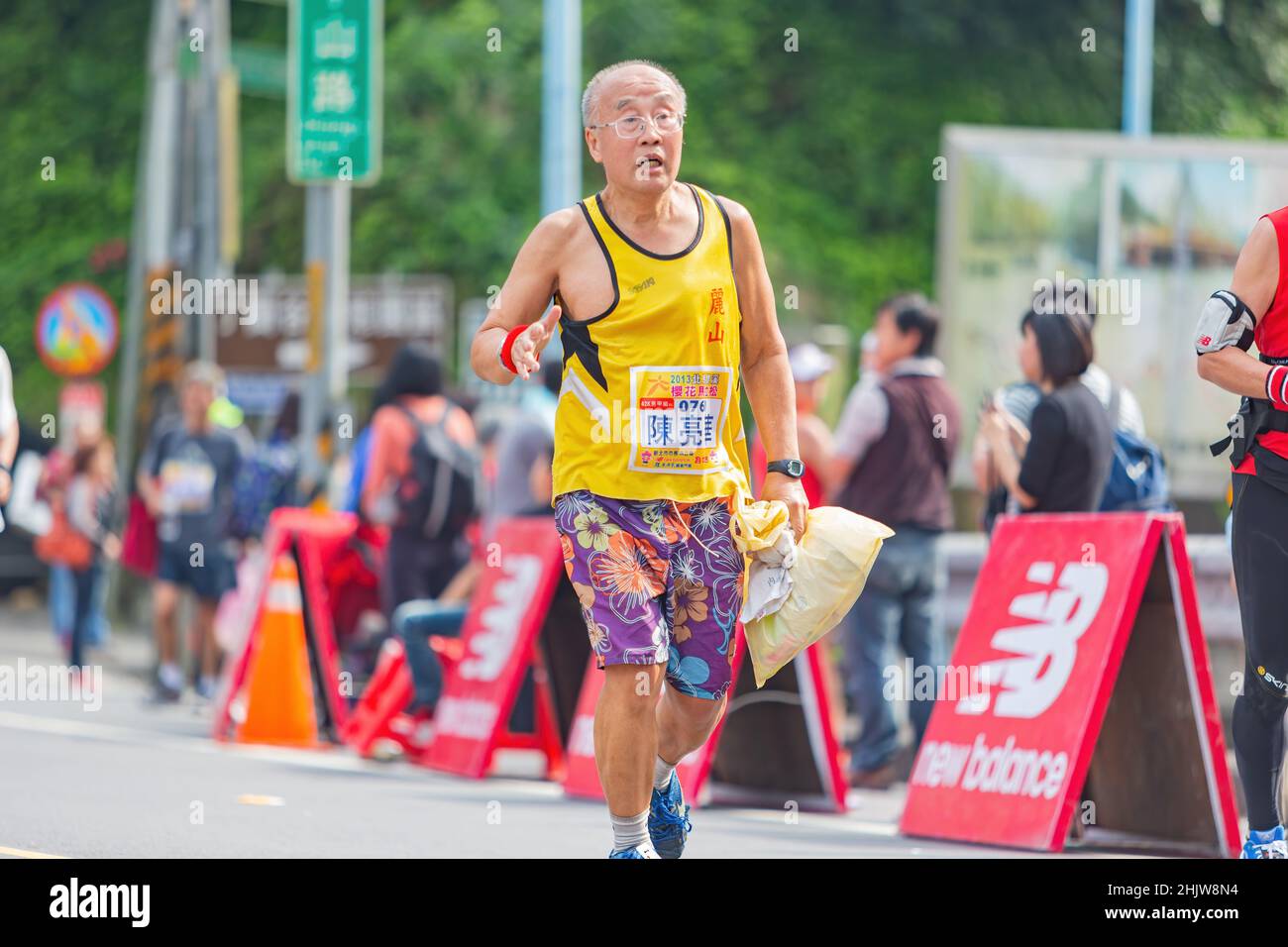 New Taipei, MAR 10 2013 - Close up shot of people running in cherry blossom marathon Stock Photo