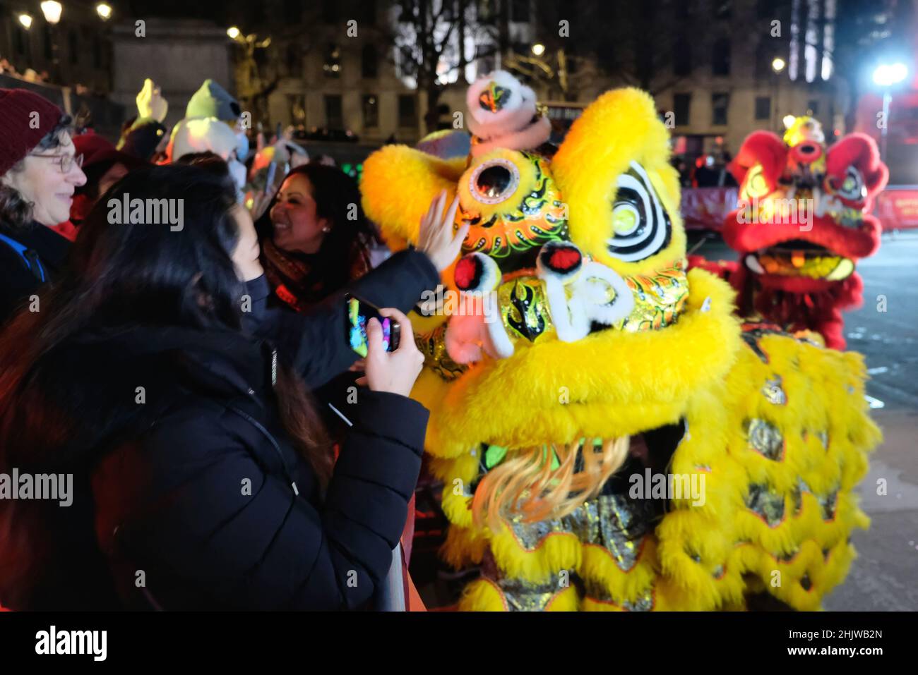 London, UK, 31st Jan, 2022.  Nelson's Column and Trafalgar Square is lit-up to celebrate Chinese New Year which falls on February 1st and ushers in the Year of the Tiger.  A lion and dragon dance was performed mainly for dignataries and officials as planned public celebrations were scaled back this year.  Credit: Eleventh Hour Photography/Alamy Live News Stock Photo