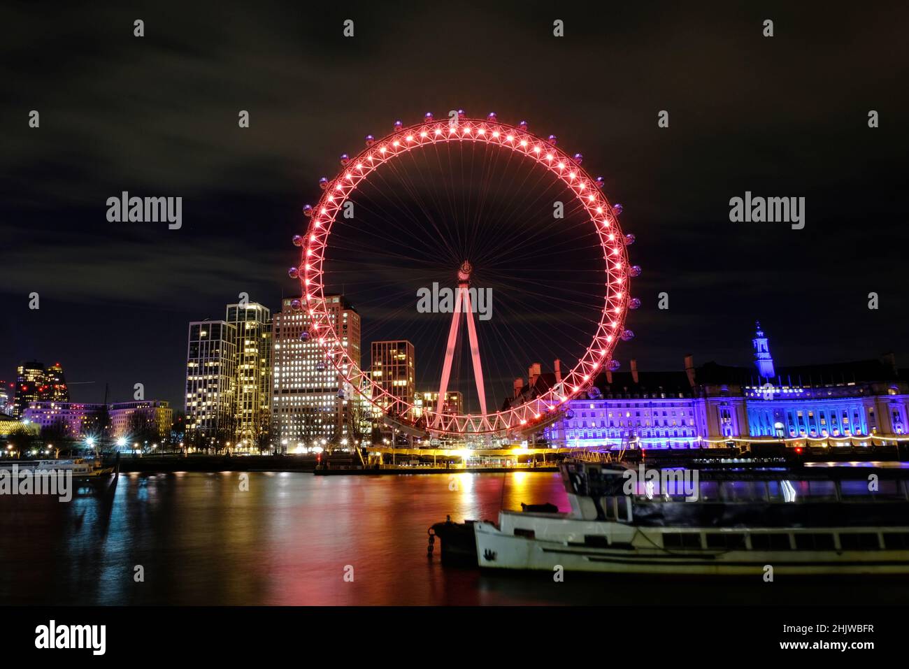 London, UK, 31st Jan, 2022. The London Eye, as seen from the River Thames is lit-up in red to celebrated the Lunar New Year - or Chinese New Year which falls on the 1st February. Credit: Eleventh Hour Photography/Alamy Live News Stock Photo