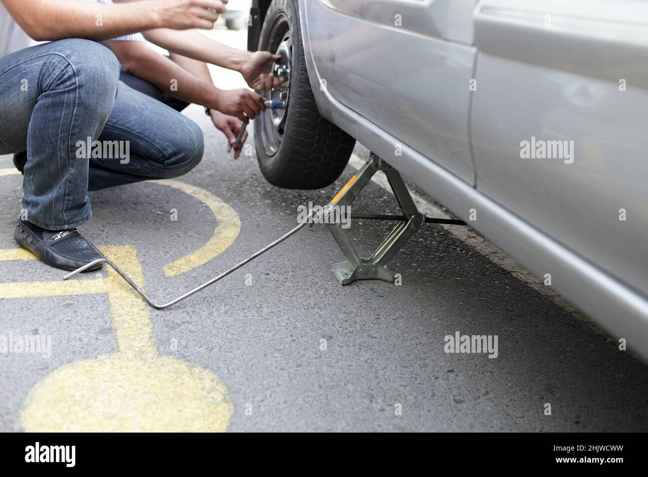 The men changing wheel on the road Stock Photo Alamy