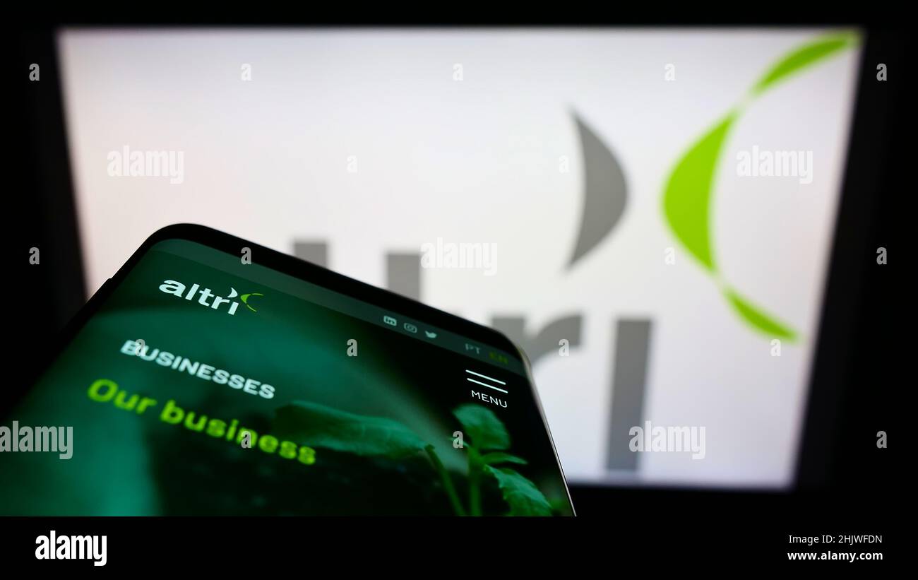 Mobile phone with webpage of Portuguese conglomerate Altri SGPS S.A. on screen in front of business logo. Focus on top-left of phone display. Stock Photo