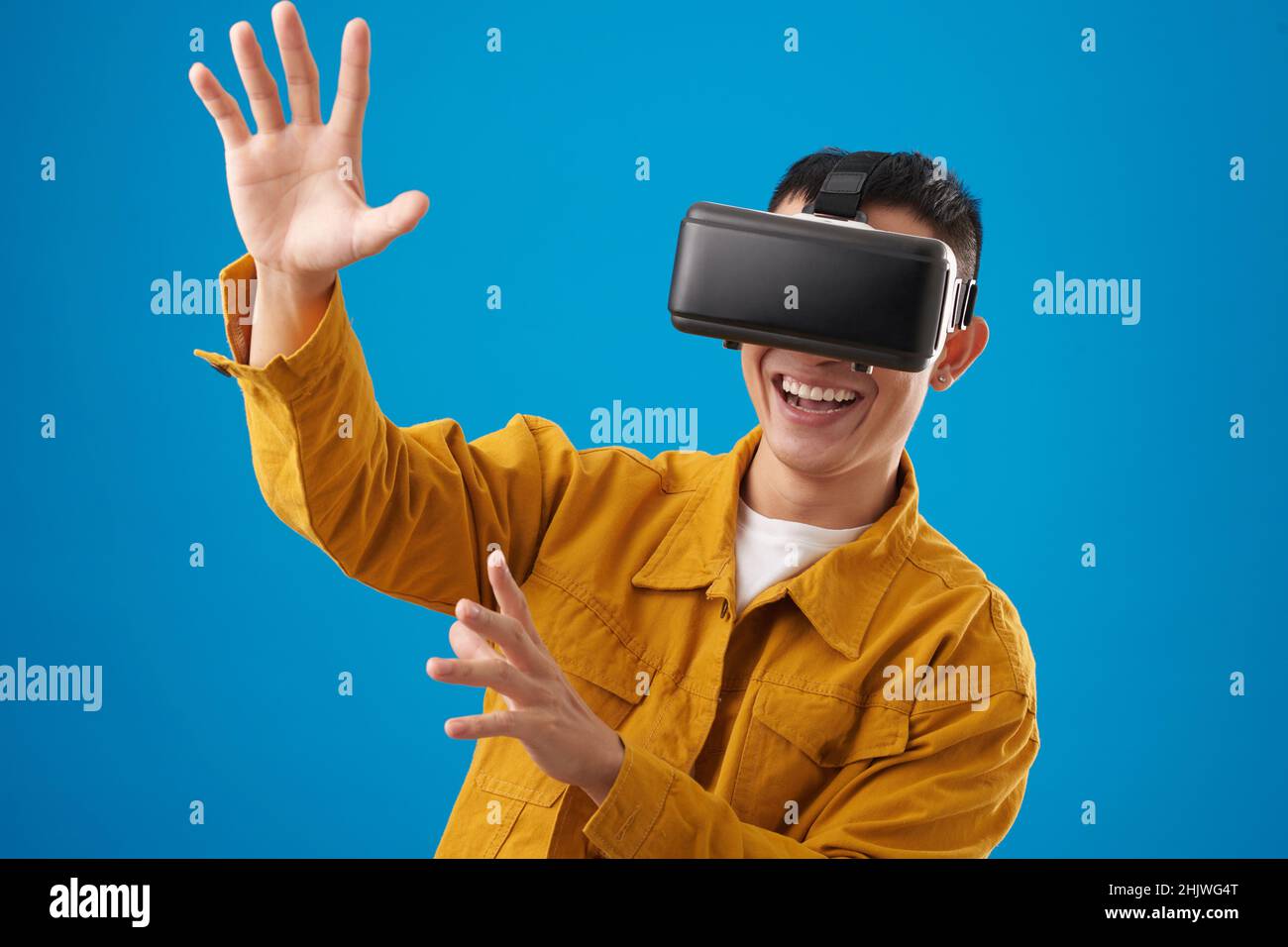 Smiling man enjoying vr simulation hi-res stock photography and images ...
