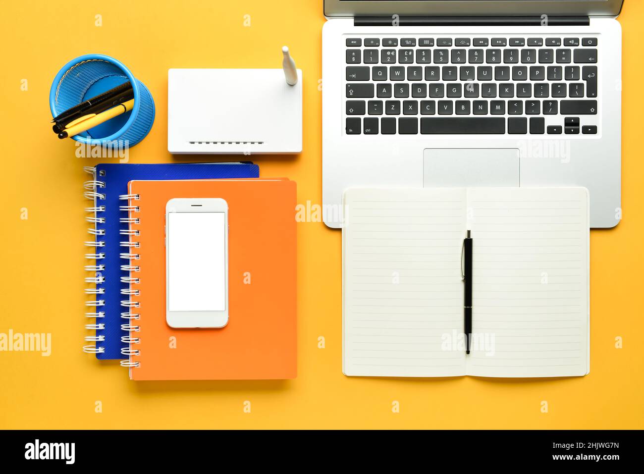 Different gadgets and stationery on color background Stock Photo