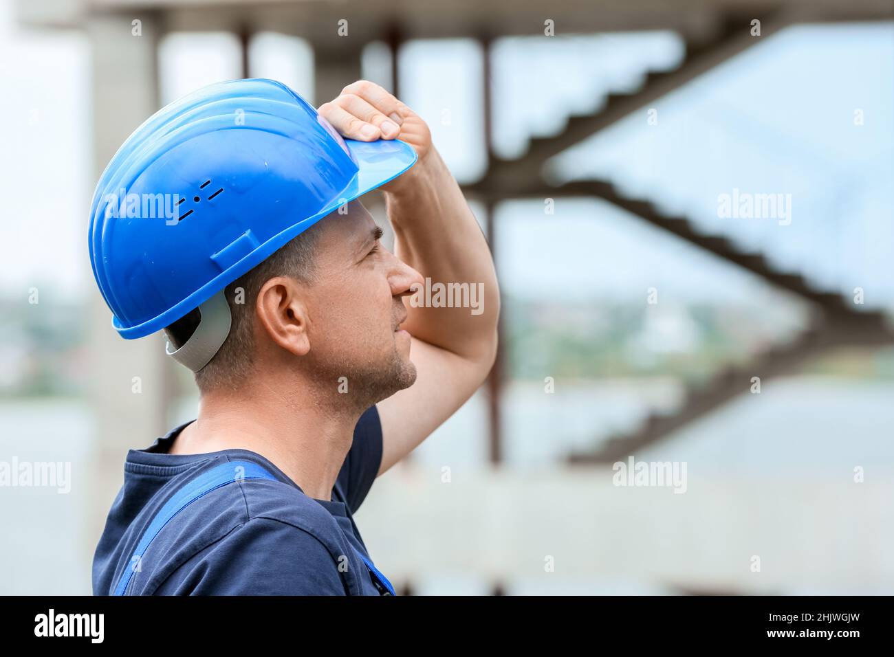 Male worker with safety hardhat at construction site Stock Photo - Alamy