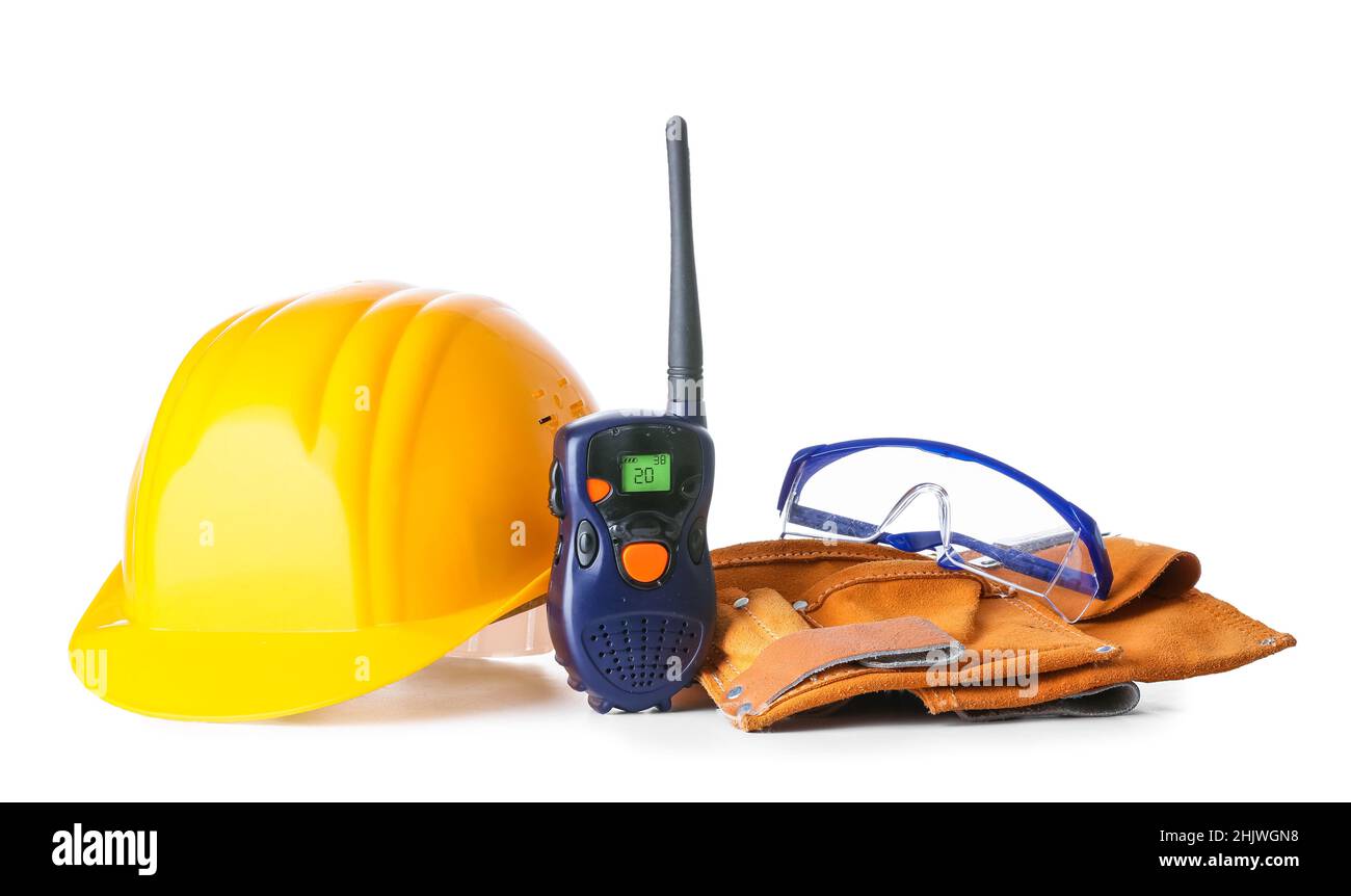 Safety equipment and radio transmitter on white background Stock Photo