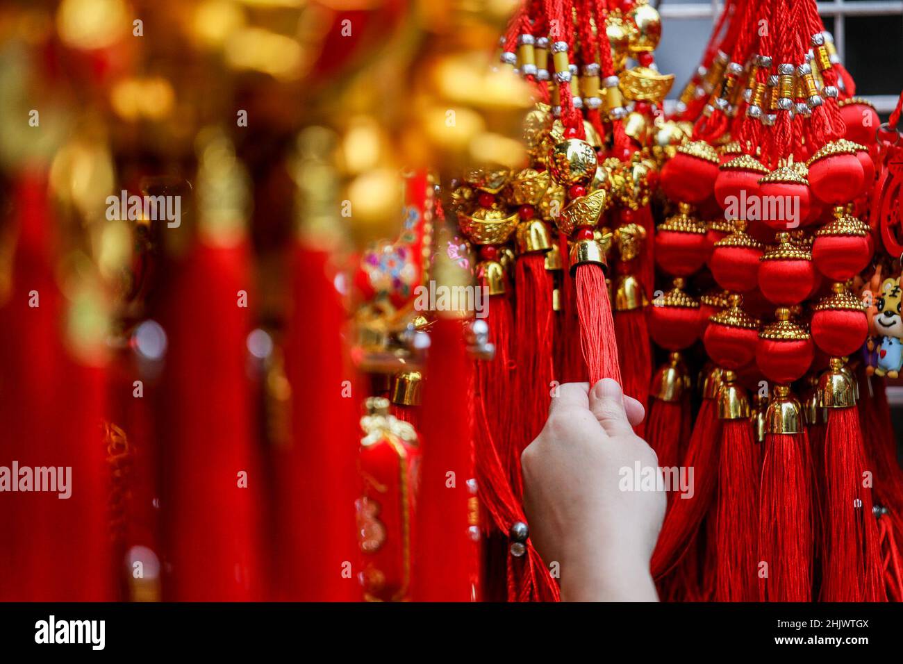 Manila, Philippines. 1st Feb, 2022. A woman shops for lucky charms in celebration of the Lunar New Year near the Seng Guan temple in Manila's Chinatown, in the Philippines. February 1, 2022. The 2022 Lunar New Year marks the Year of the Tiger in the Chinese zodiac calendar, representing bravery, courage and strength. (Credit Image: © Basilio Sepe/ZUMA Press Wire) Stock Photo
