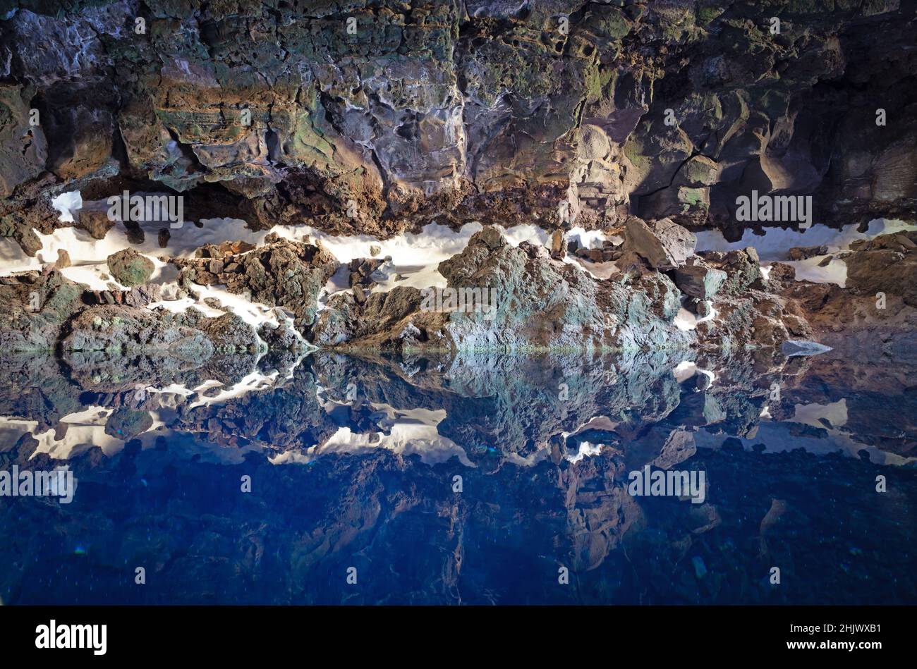 Cave on Lanzarote, reflection in the blue cold water (Spain Stock Photo