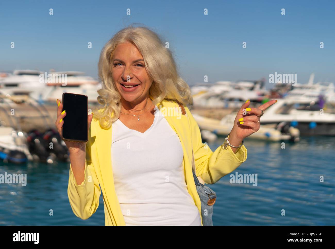 Woman showing smartphone  Stock Photo