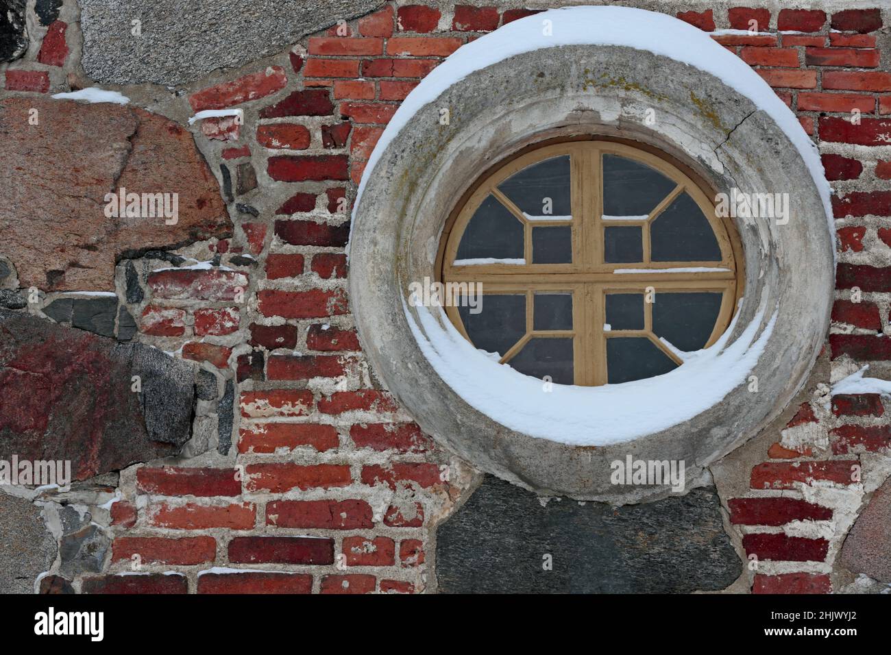 A small round and decorative window of an ancient church Stock Photo
