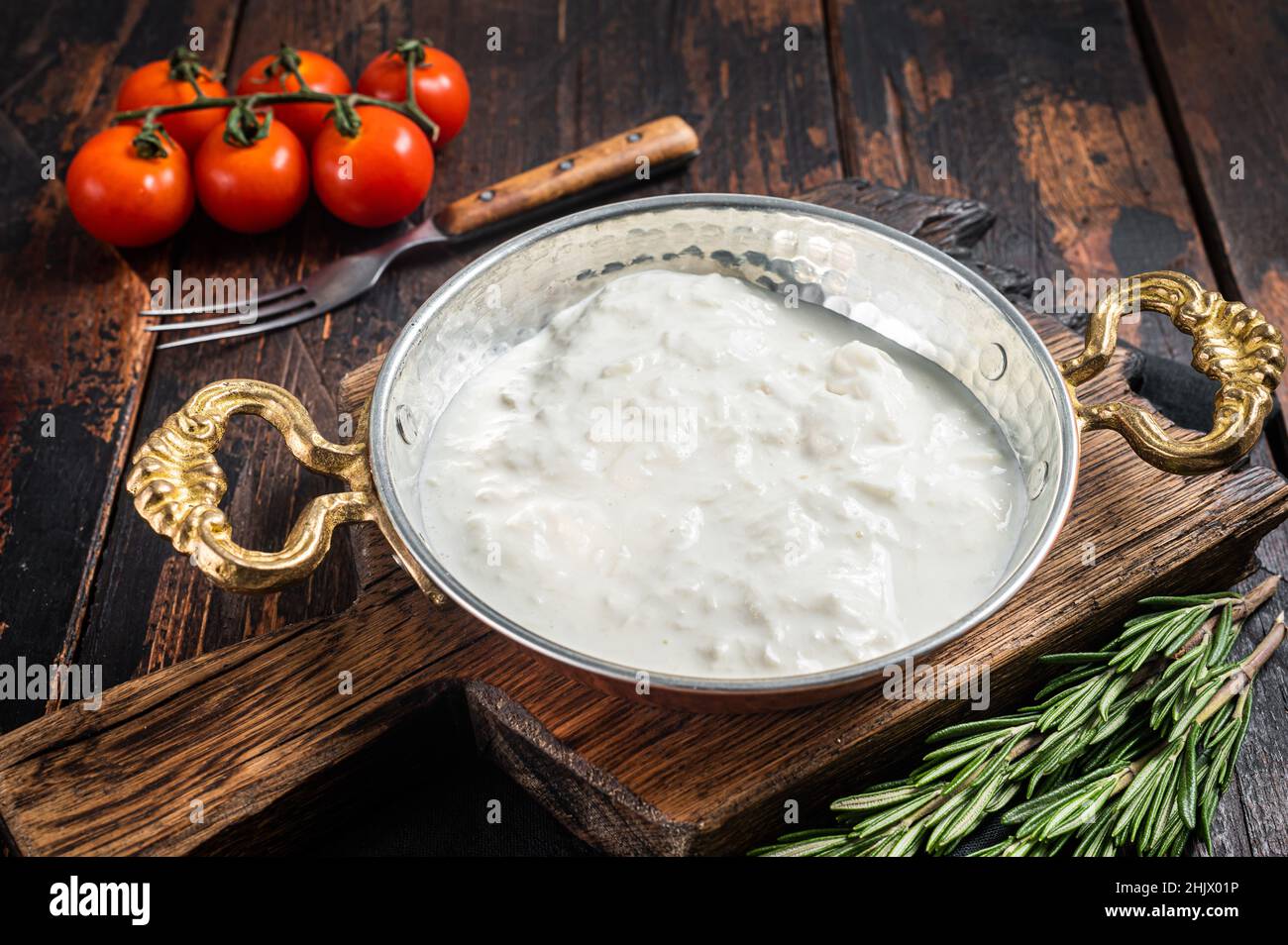 Straciatella fresh italian creamy cheese. Wooden background. Top view Stock Photo